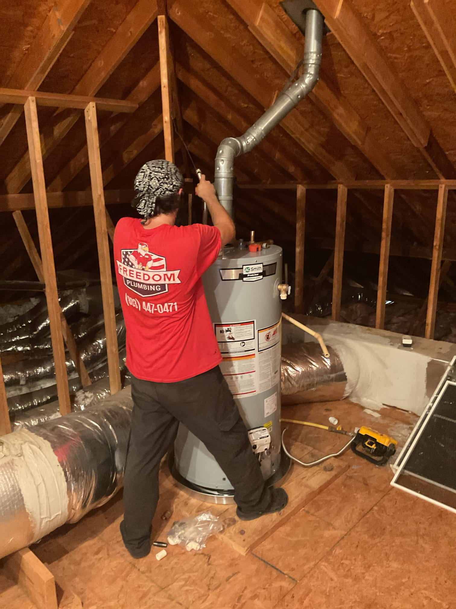 Freedom Plumbing technician installing a water heater