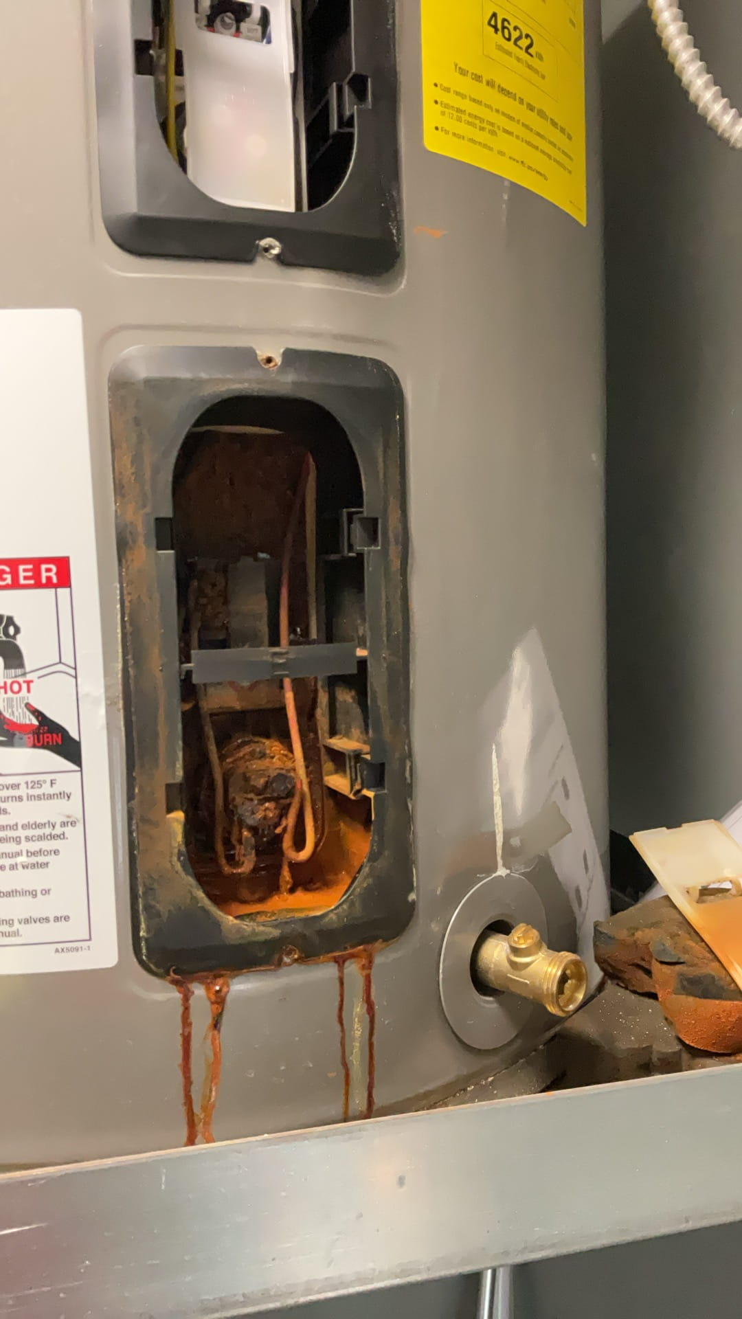 Rusty sediment buildup on water heater panel