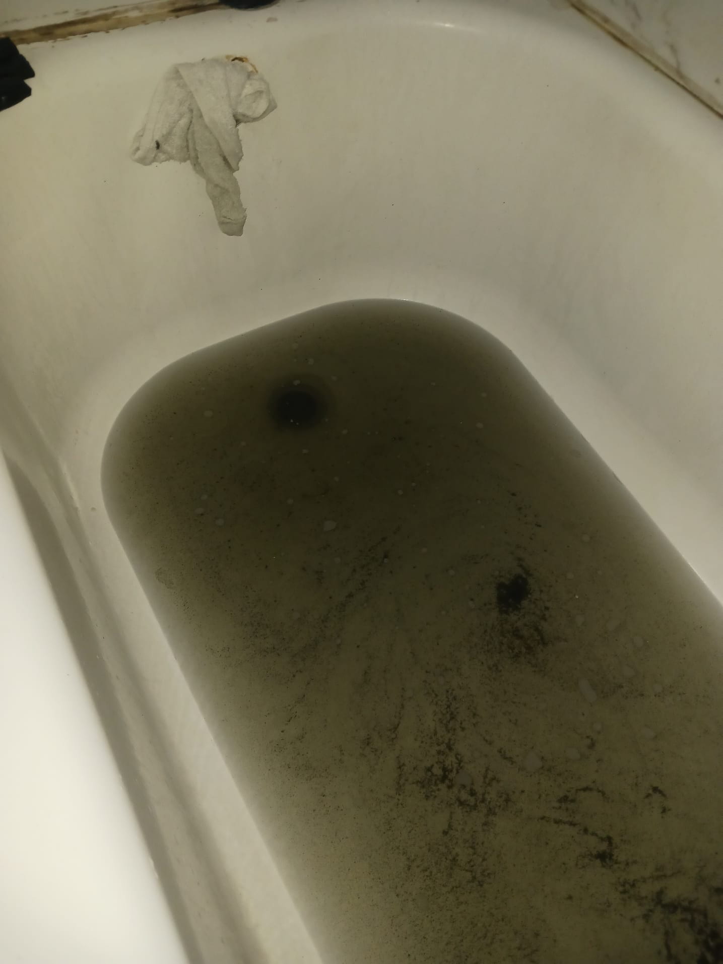 Clogged tub drain with dirty water backup