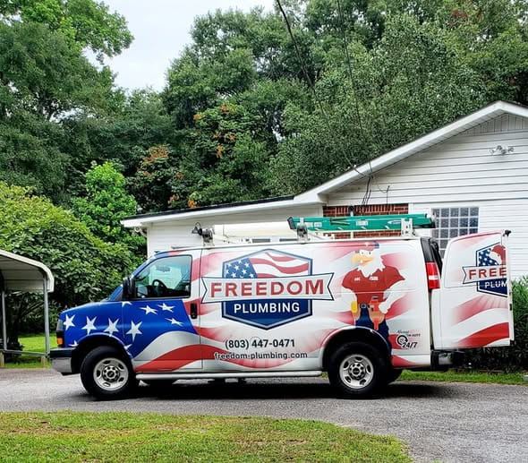 Freedom Plumbing service truck parked at a customer's home in Lexington, SC