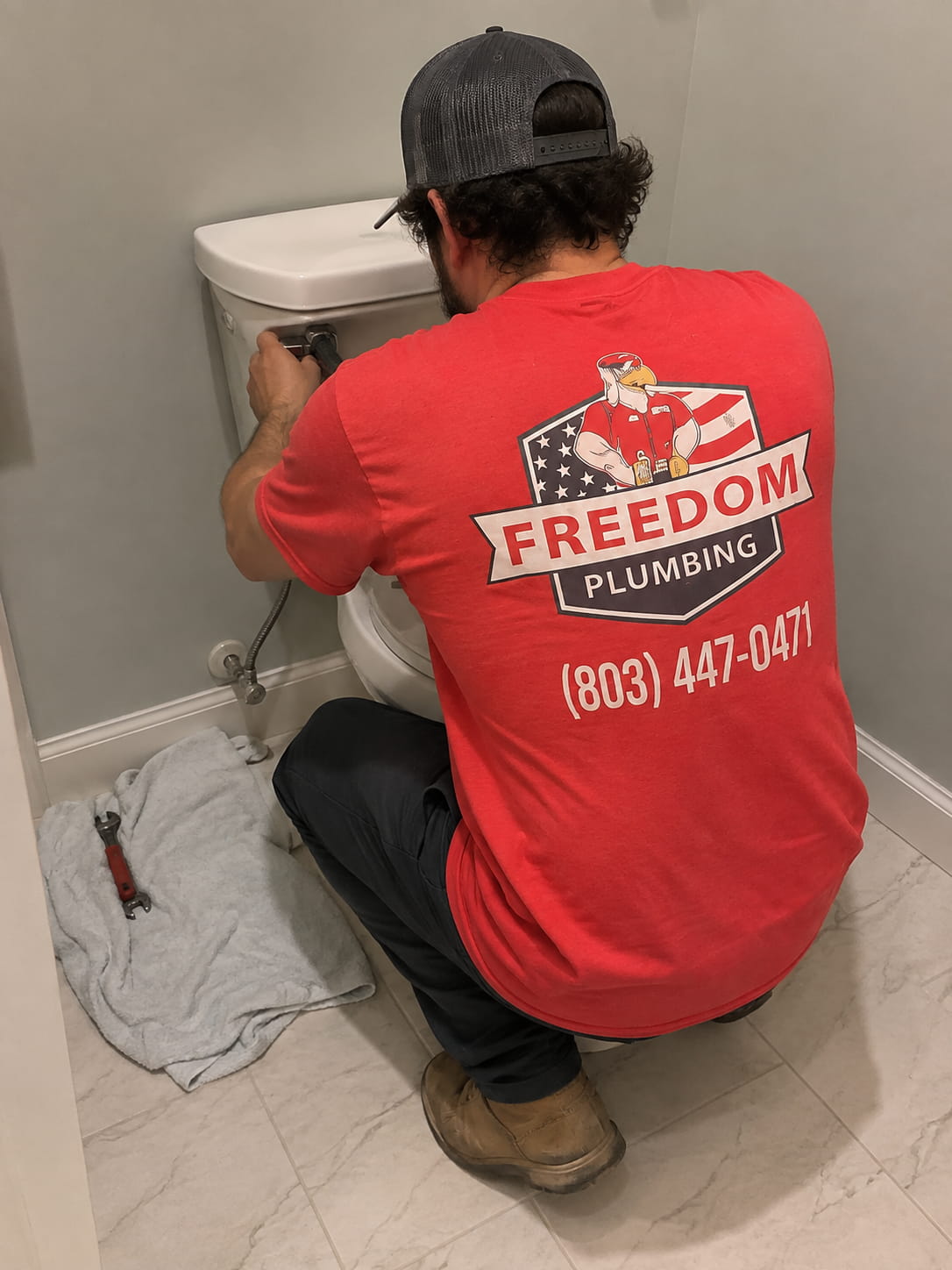 Licensed Freedom Plumbing technician repairing a toilet in a Lexington, SC home